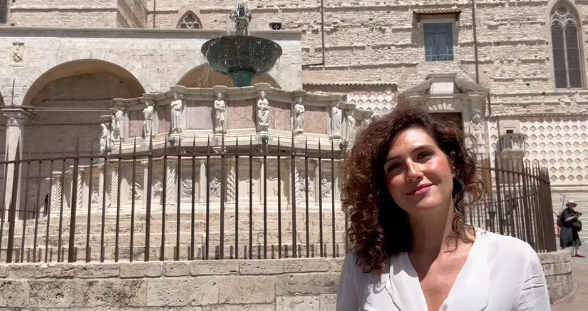 Deputy Mayor Clara Pastorelli poses in front of the famous fountain in Perugia, with greetings from our sister city to the people of Grand Rapids.